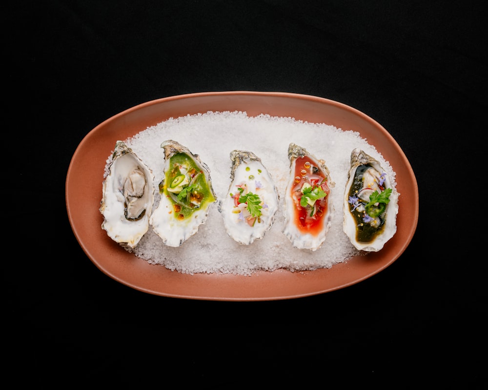 a plate of oysters on a bed of ice