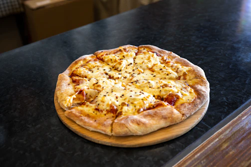 A 16-inch cheese pizza with perfectly melted golden cheese and a crispy crust, ready to be shared.