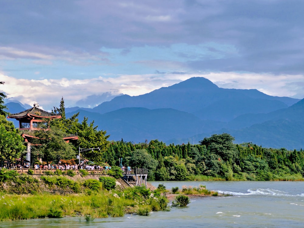 a scenic view of a river with a pagoda in the background