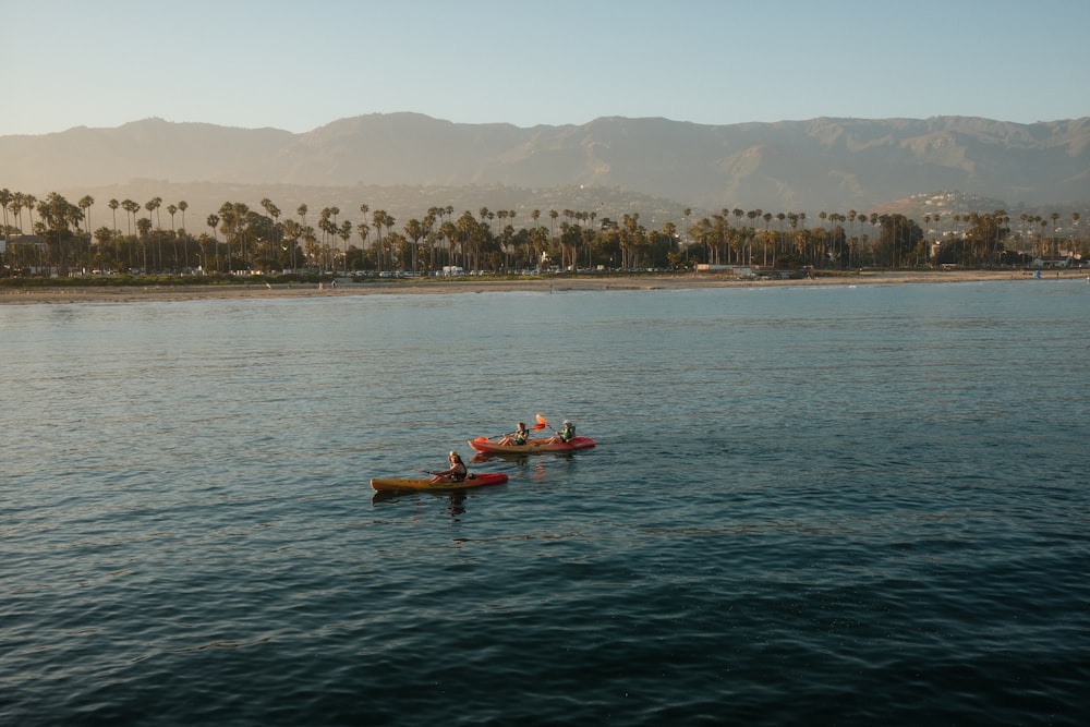 a couple of boats floating on top of a lake