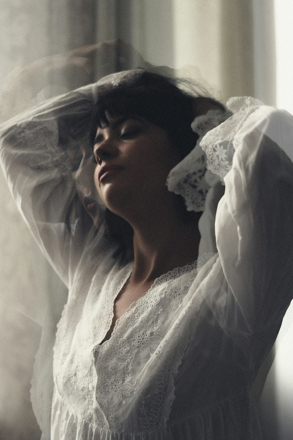 a woman in a white dress with a veil over her head