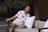 A happy customer wearing a sleek lounge set from sassy street wear, smiling outdoors.