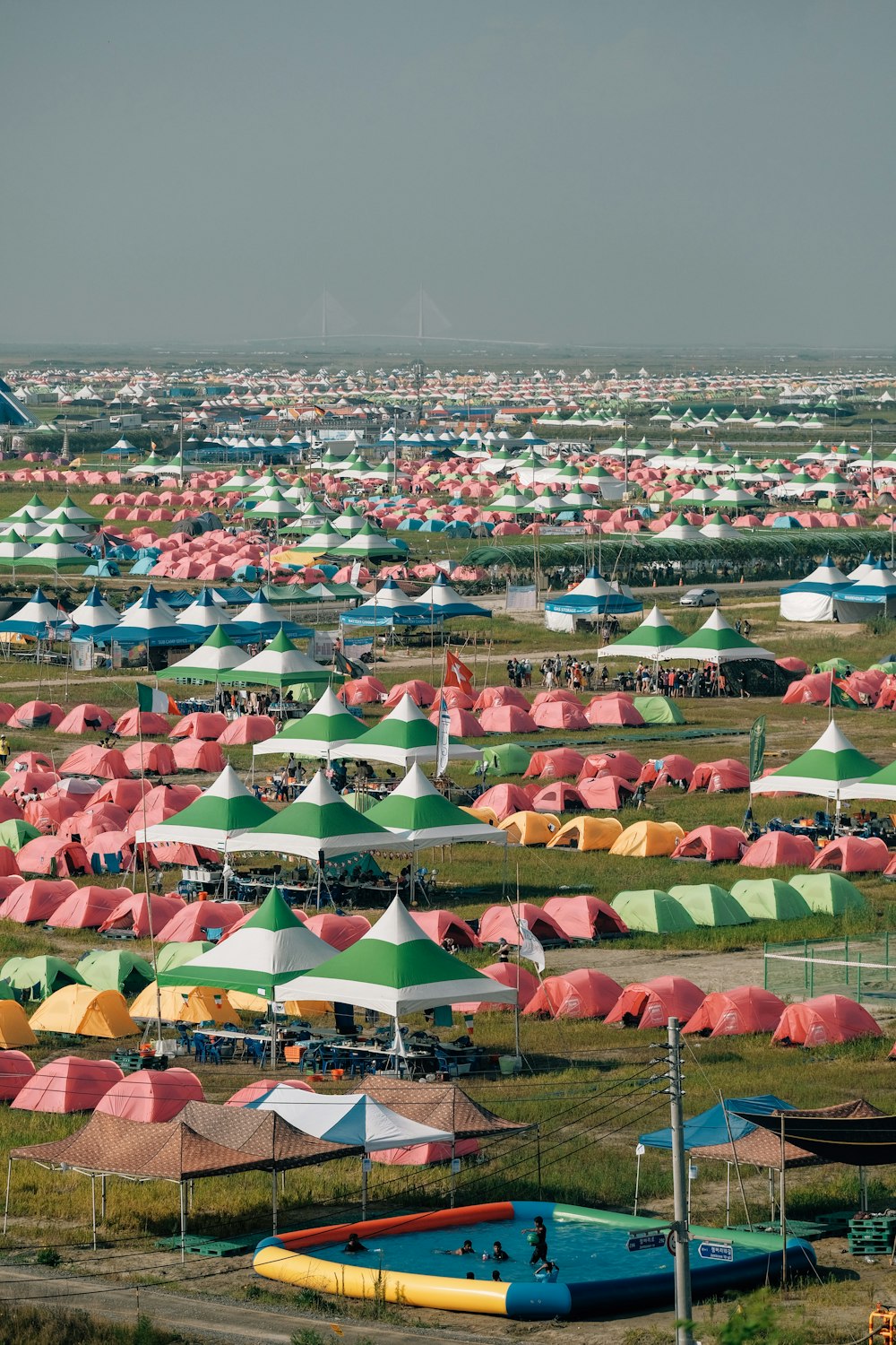 a field full of tents with a sky in the background