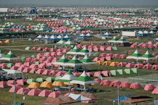 A panoramic view of the festival grounds bustling with visitors and colorful tents.