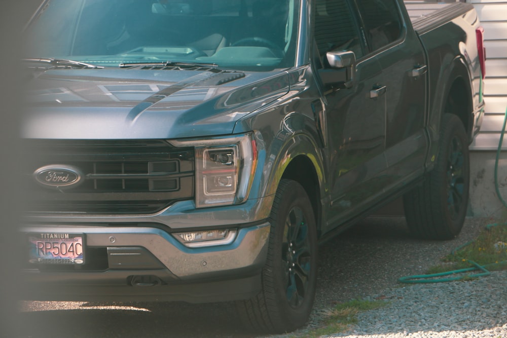 a black truck parked in front of a house