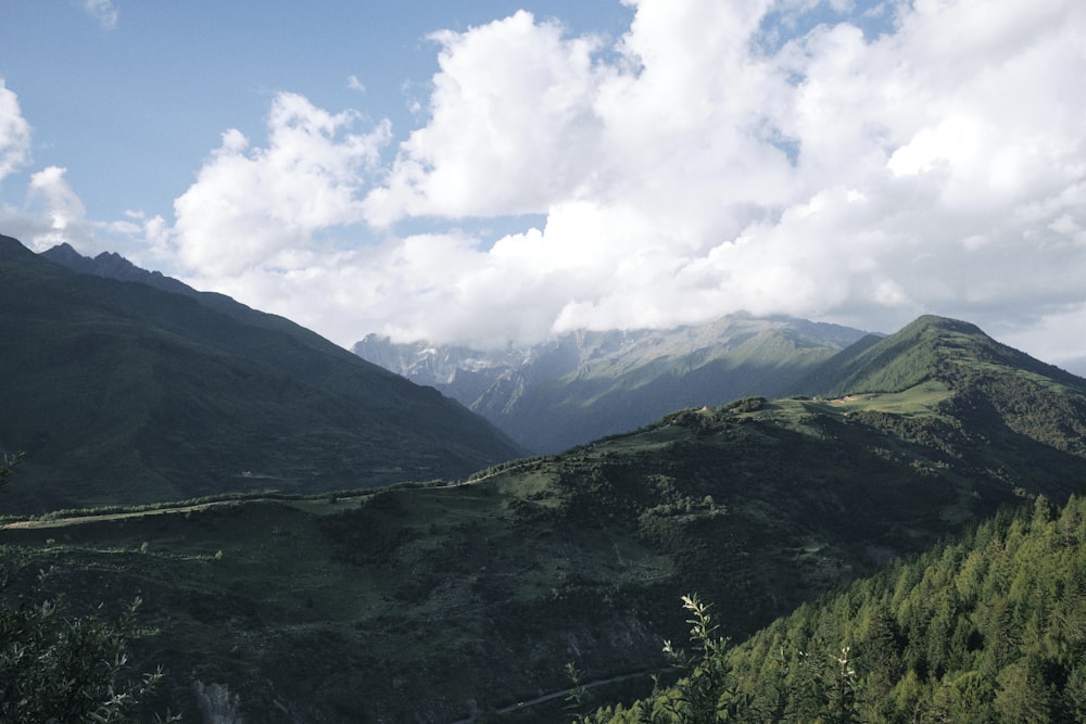 a scenic view of a mountain range with clouds in the sky