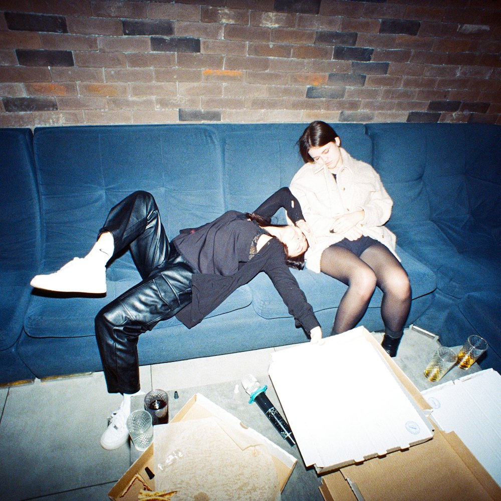 a man and a woman laying on a couch