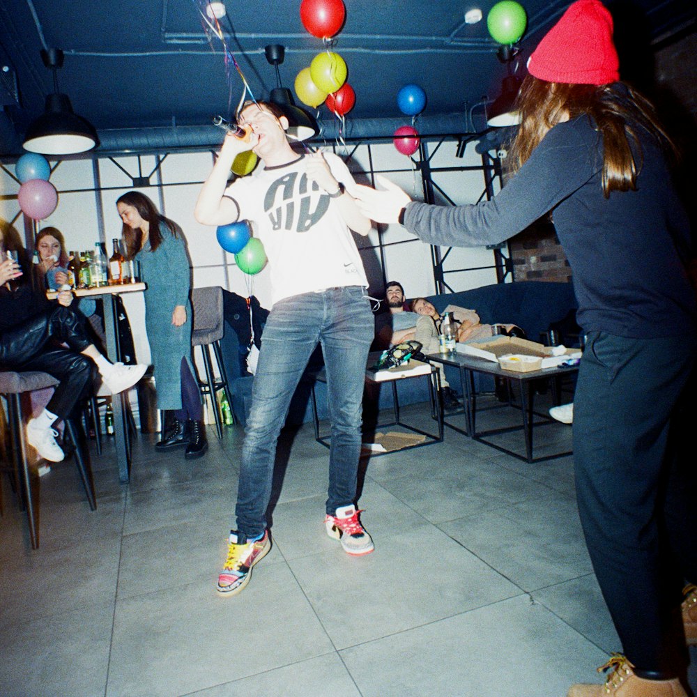 a group of people in a room with balloons