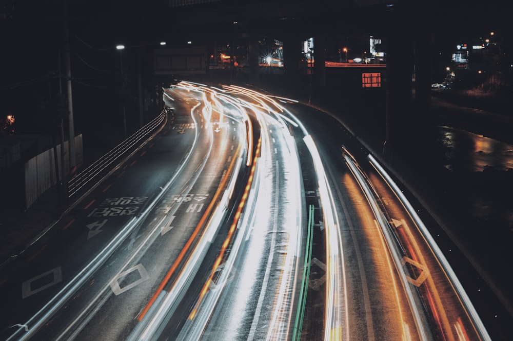 a city street filled with lots of traffic at night