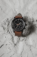Titan World chronograph watch with detailed dials and a sturdy black leather strap.