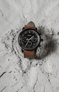 Titan World chronograph watch with detailed dials and a sturdy black leather strap.