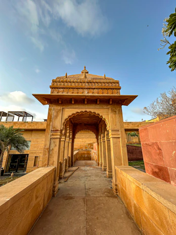 A beautifully carved sandstone temple entrance glowing under the warm Rajasthan sun.