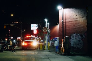 Nighttime scene of a water tanker with lights on, providing emergency water service.
