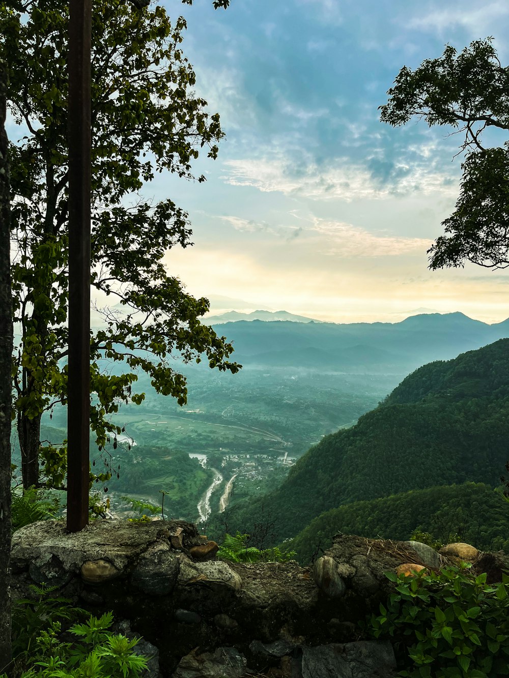 a scenic view of a valley and mountains