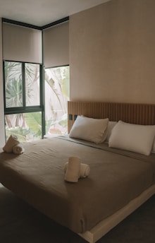 a bedroom with a large bed and a window