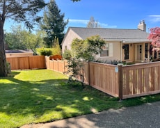 a house with a wooden fence in front of it