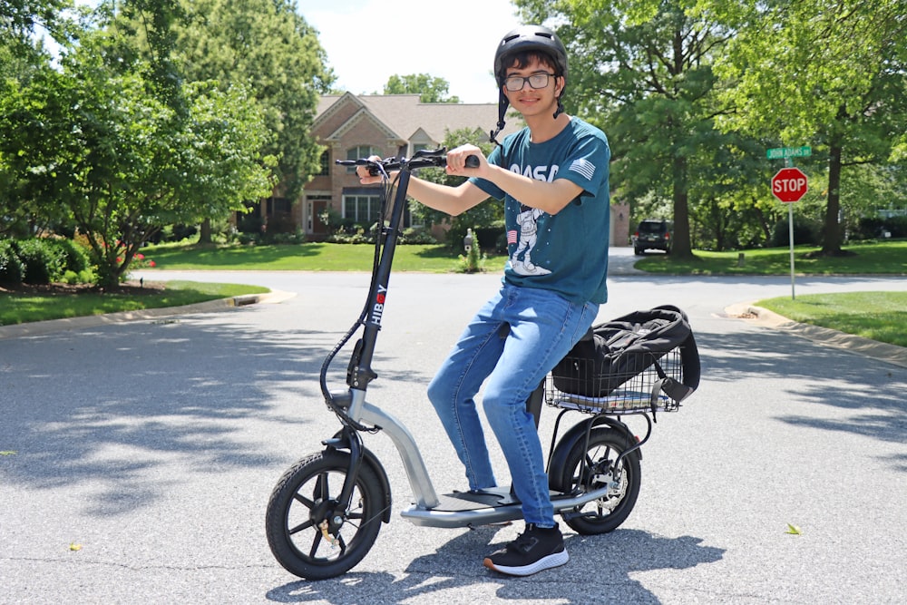 a man riding an electric scooter on a street