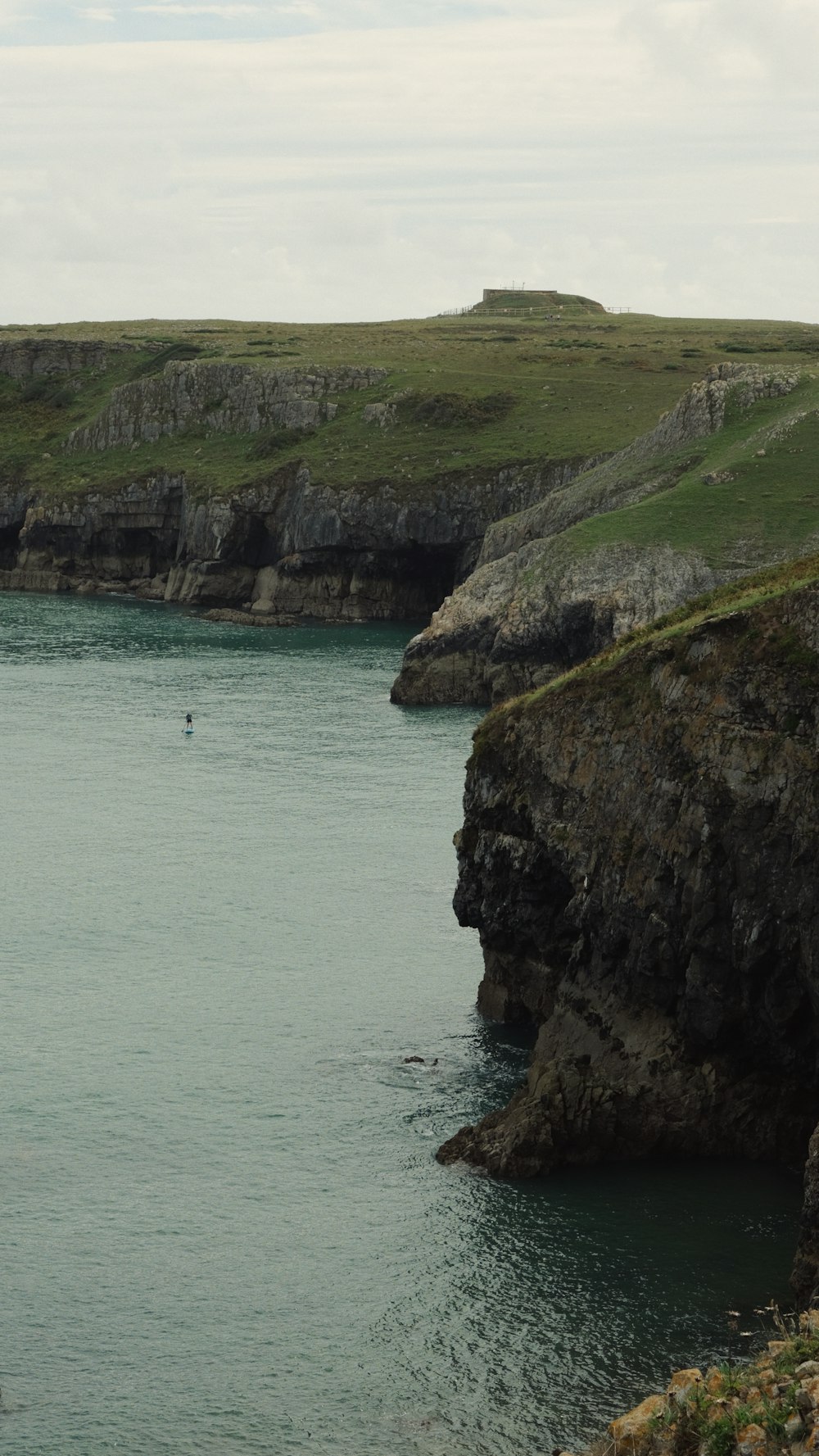 a body of water near a rocky cliff