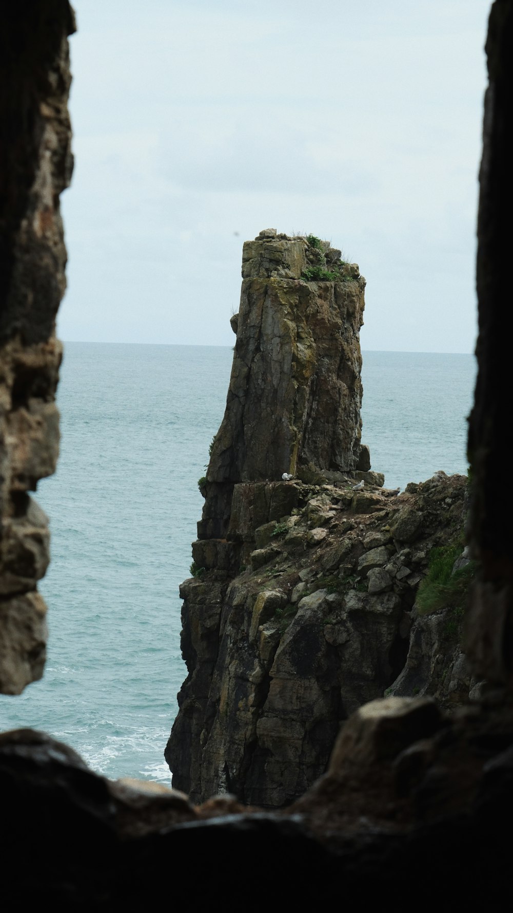 a rock outcropping in the middle of the ocean