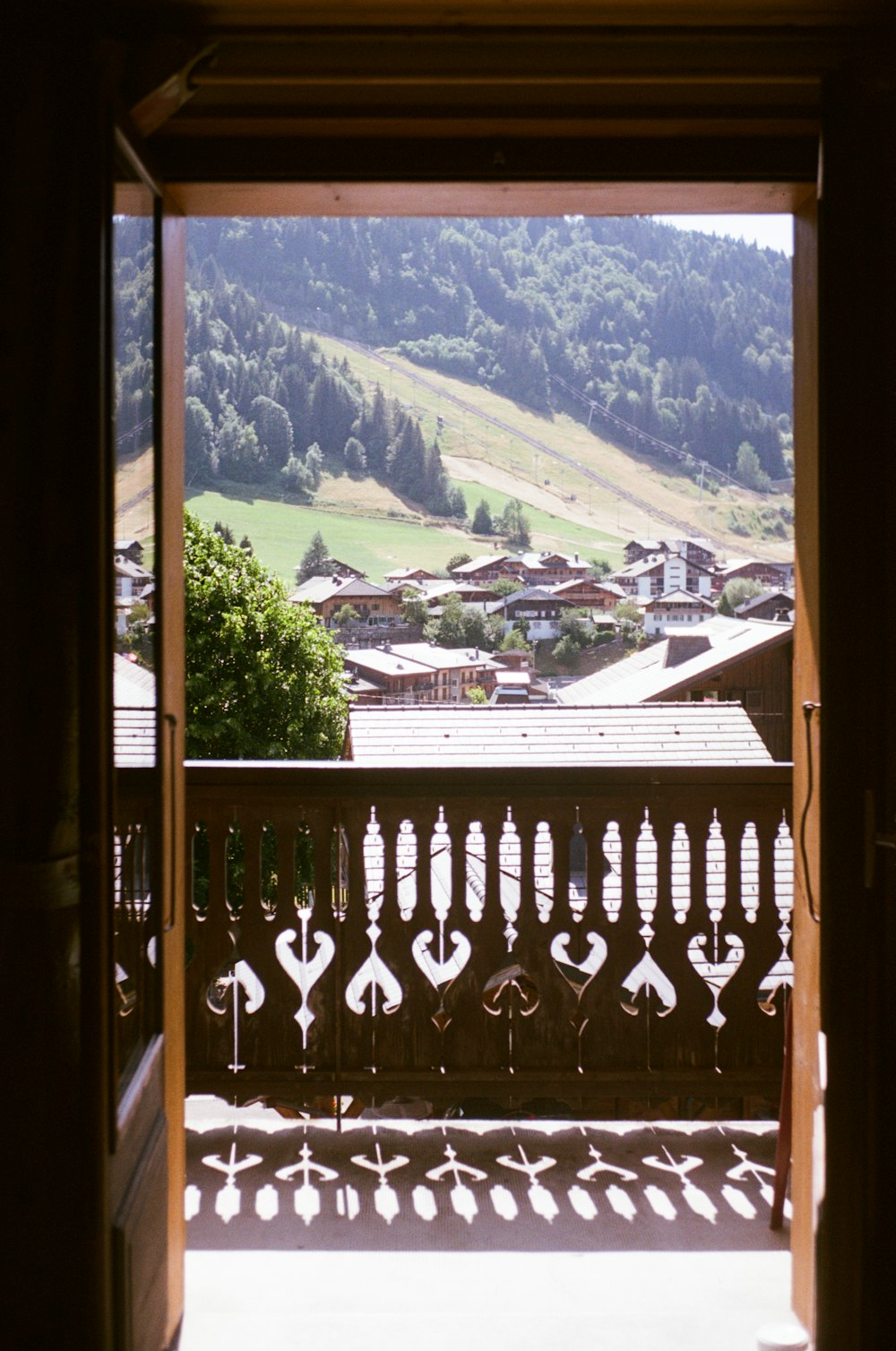 an open door with a view of a town in the distance
