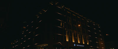 Nighttime shot of a luxury hotel entrance with subtle lighting.