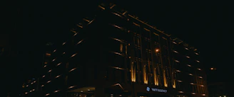 Nighttime shot of a luxury hotel entrance with subtle lighting.