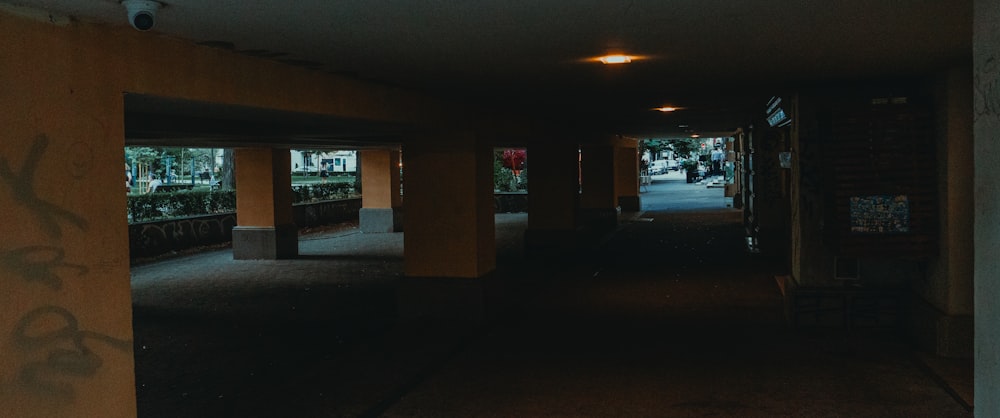 a dark hallway with graffiti on the walls