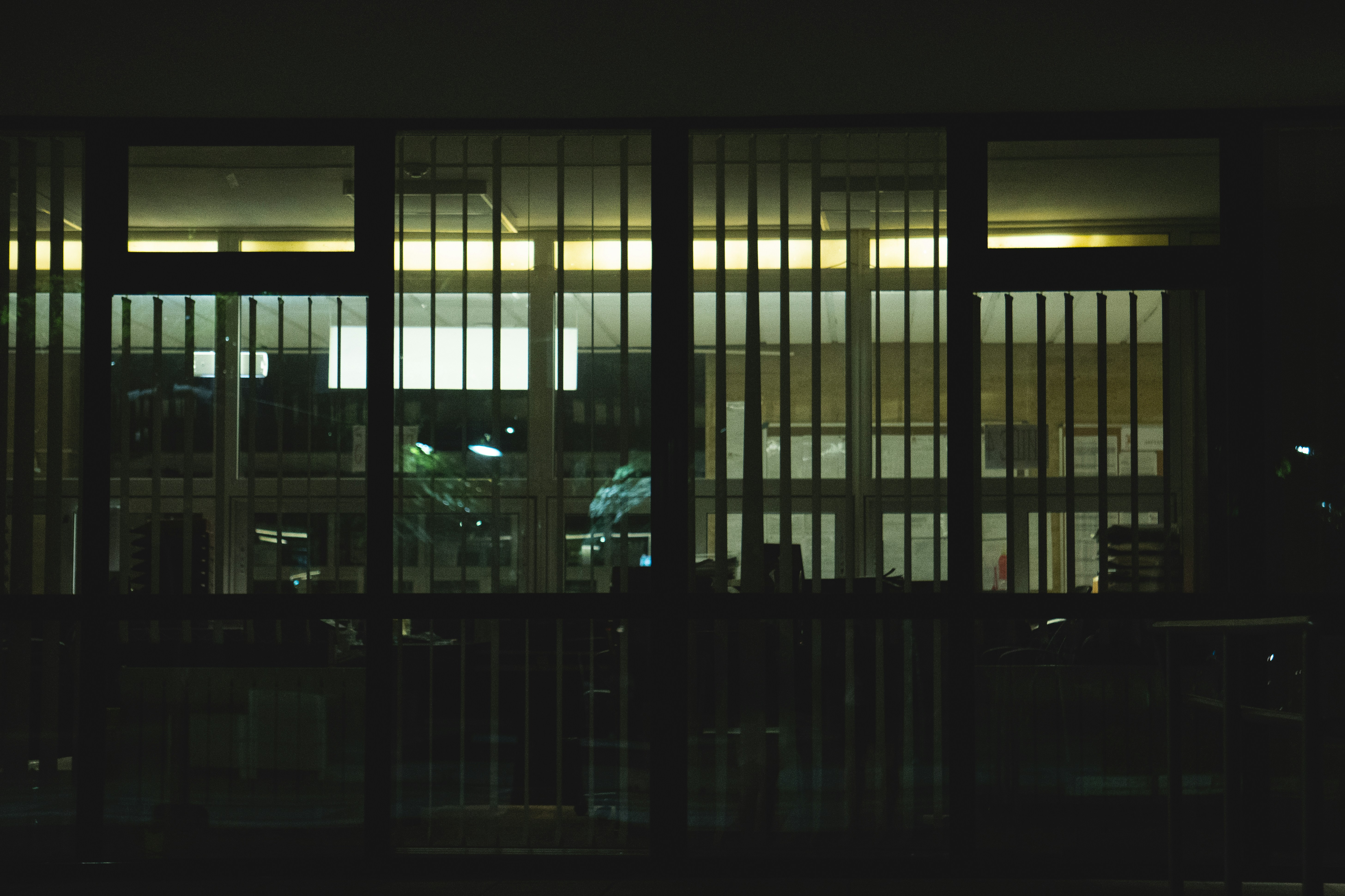 a view of a building through a window at night
