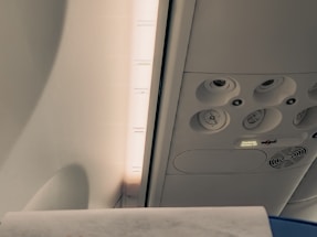 A technician inspecting aircraft cabin ventilation with specialized equipment.