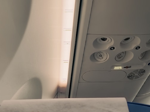 A technician inspecting aircraft cabin ventilation with specialized equipment.