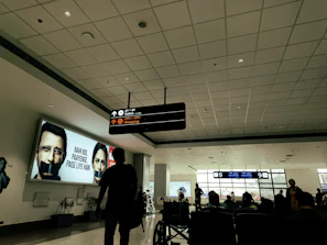 Airport terminal in Peru with travelers and signage