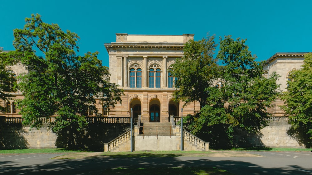 a large building with a lot of trees in front of it