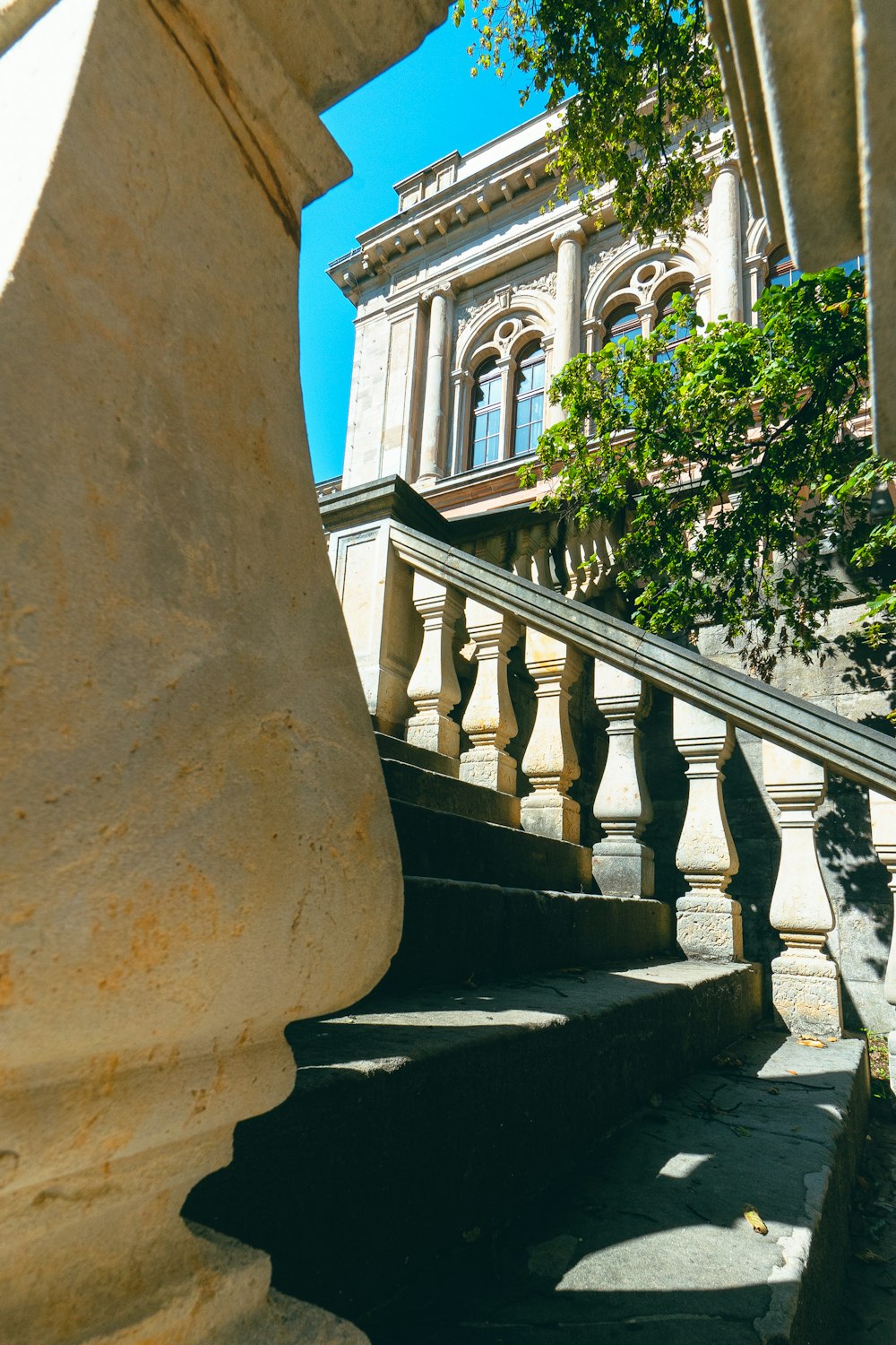 a stone staircase with a building in the background