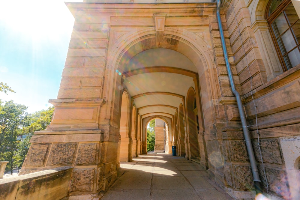 an archway leading to a building on a sunny day