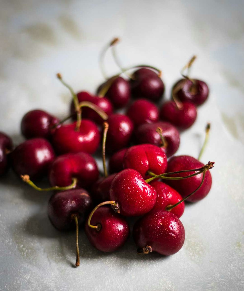 a pile of cherries sitting on top of a table