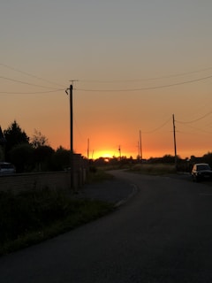 Sunset over the Catskills with a Catskill Car Service car waiting at a quiet roadside