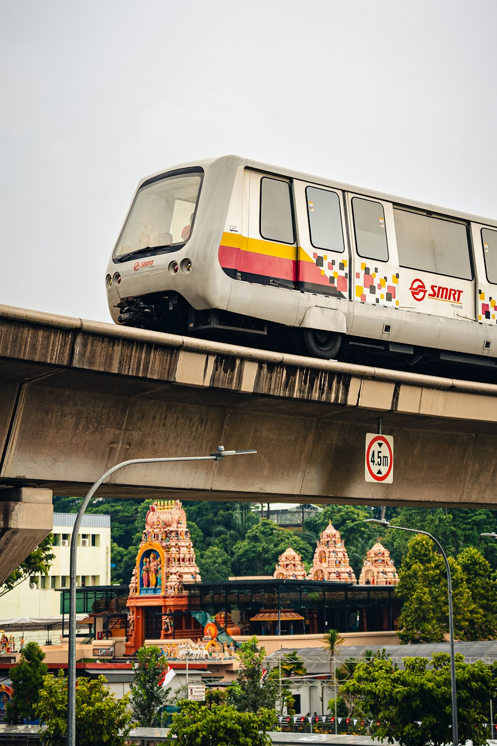 a train is going over a bridge in a city