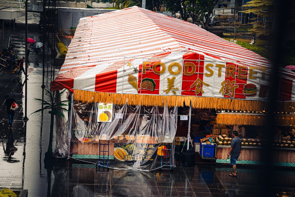 a red and white tent with a sign on it