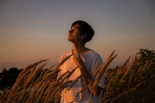 a man standing in a field of tall grass