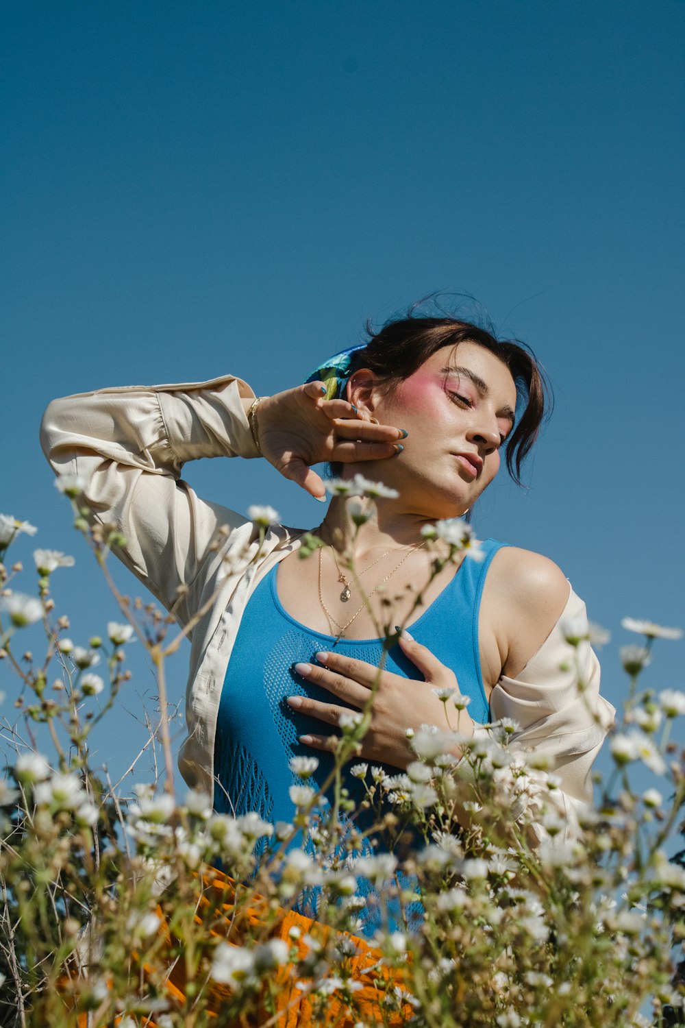 a woman standing in a field of flowers