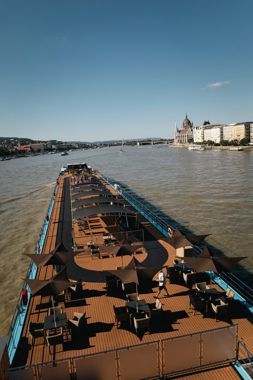 a boat traveling down a river next to a bridge