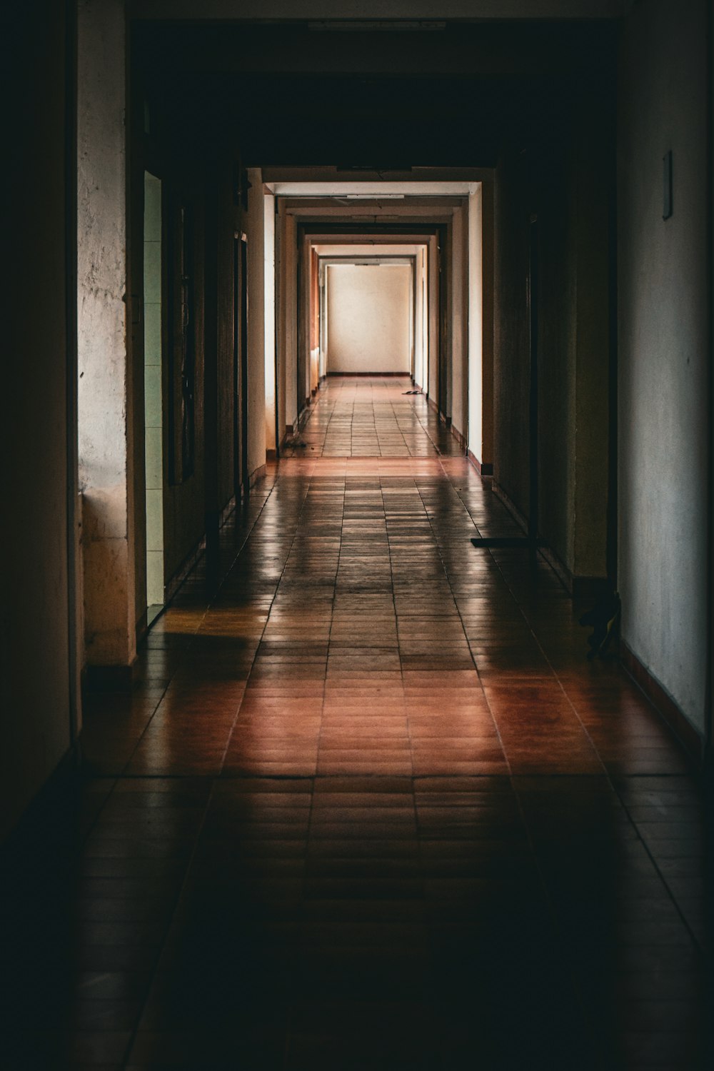 a long hallway with tiled floors and walls