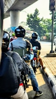 a group of people riding motorcycles down a street