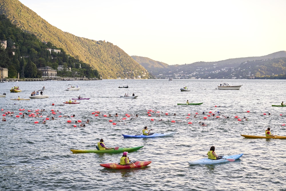 a group of people in kayaks paddling on a lake