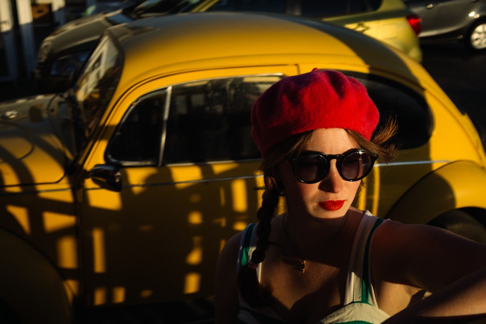 a woman wearing sunglasses and a red hat