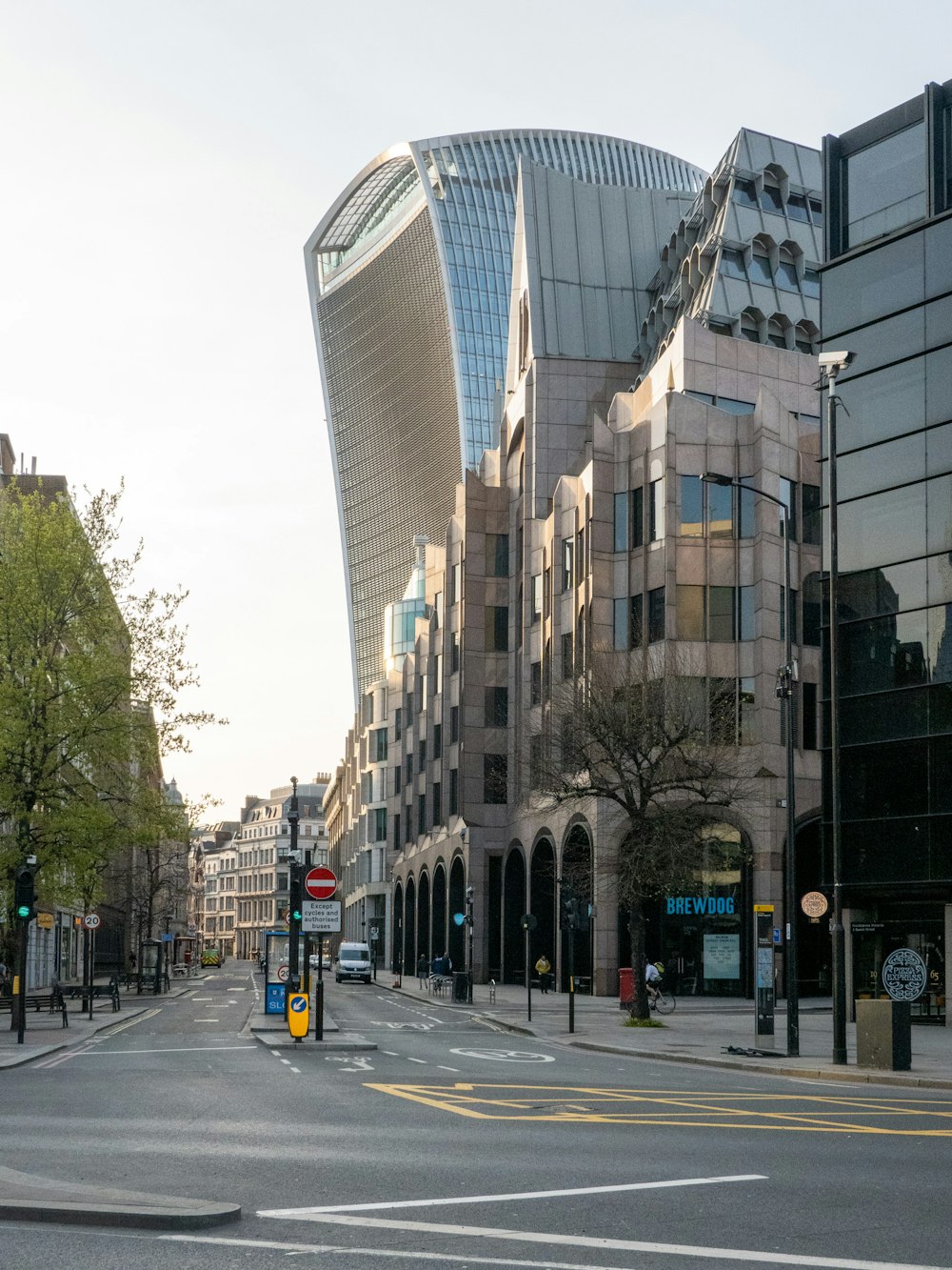 a city street with tall buildings and a traffic light