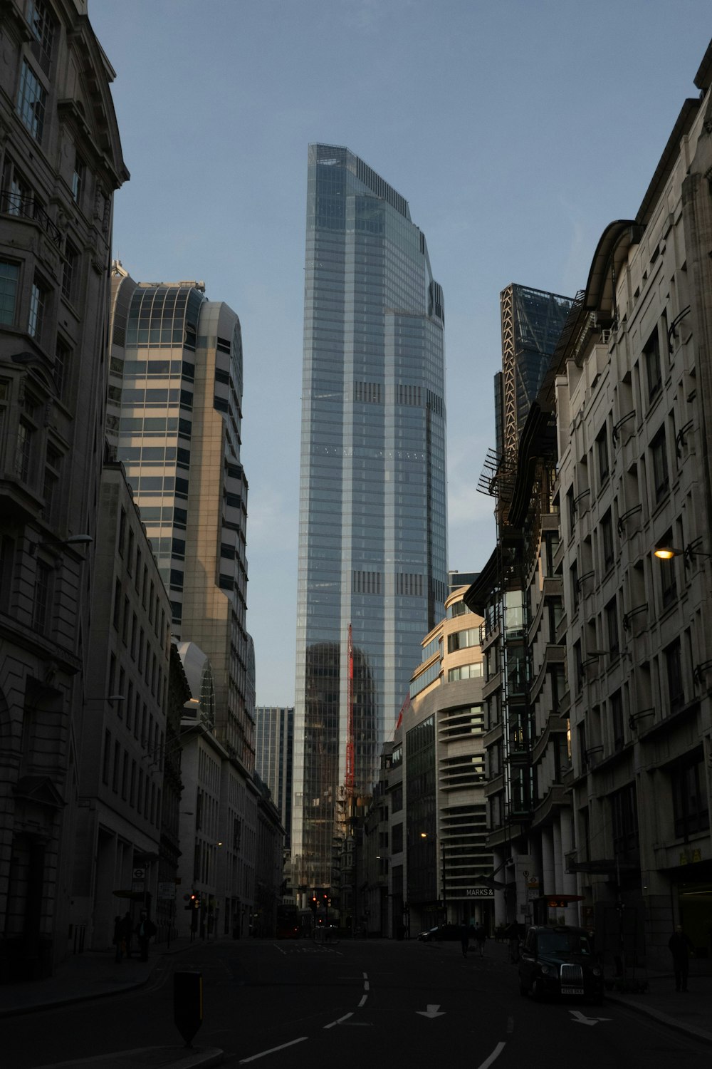 a city street with tall buildings in the background