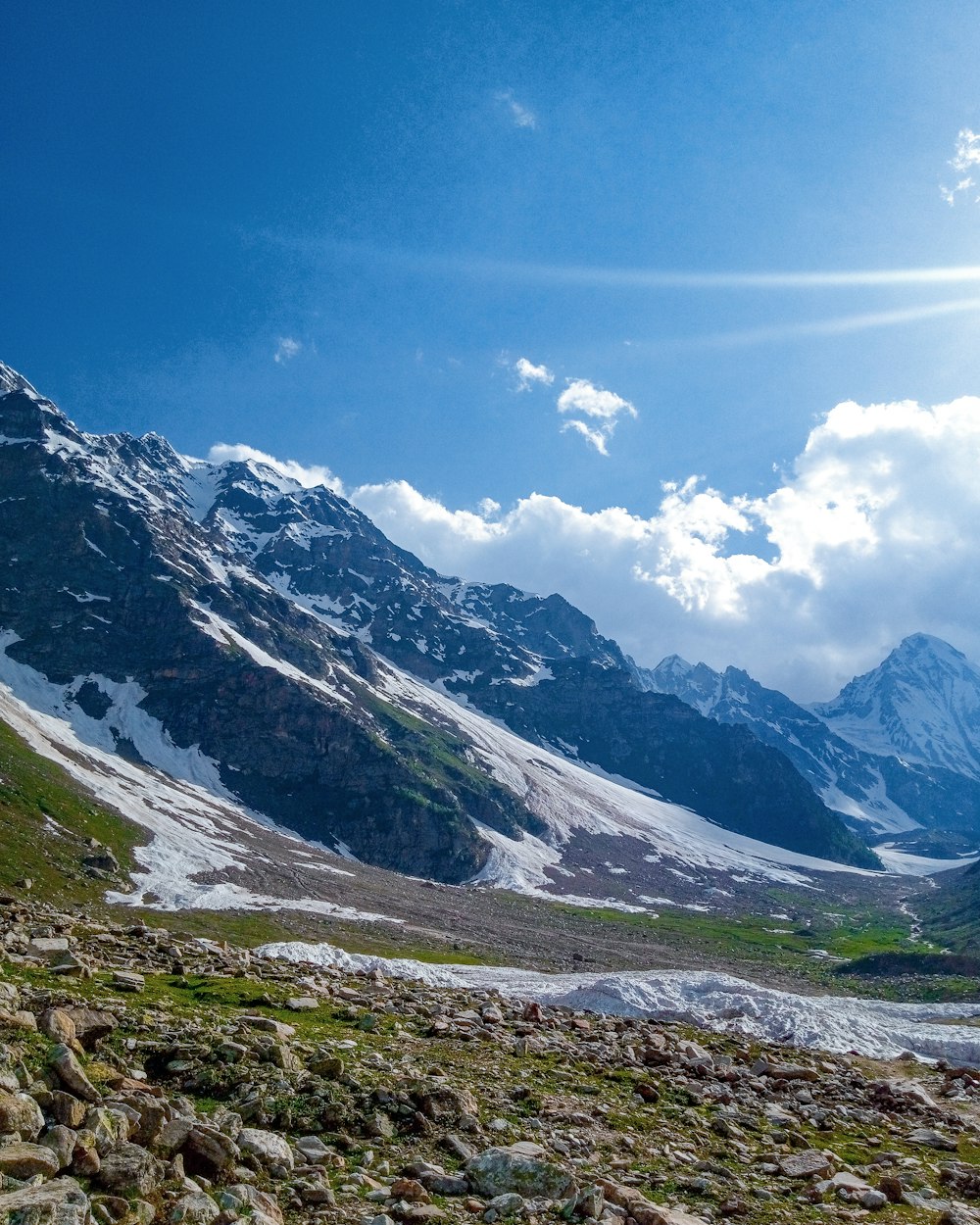 a view of a mountain range with snow on it