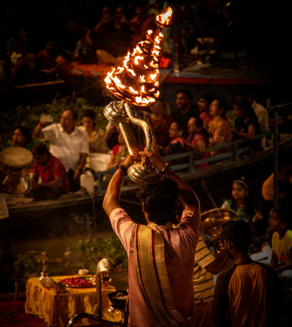 a man holding a metal object on top of a stage