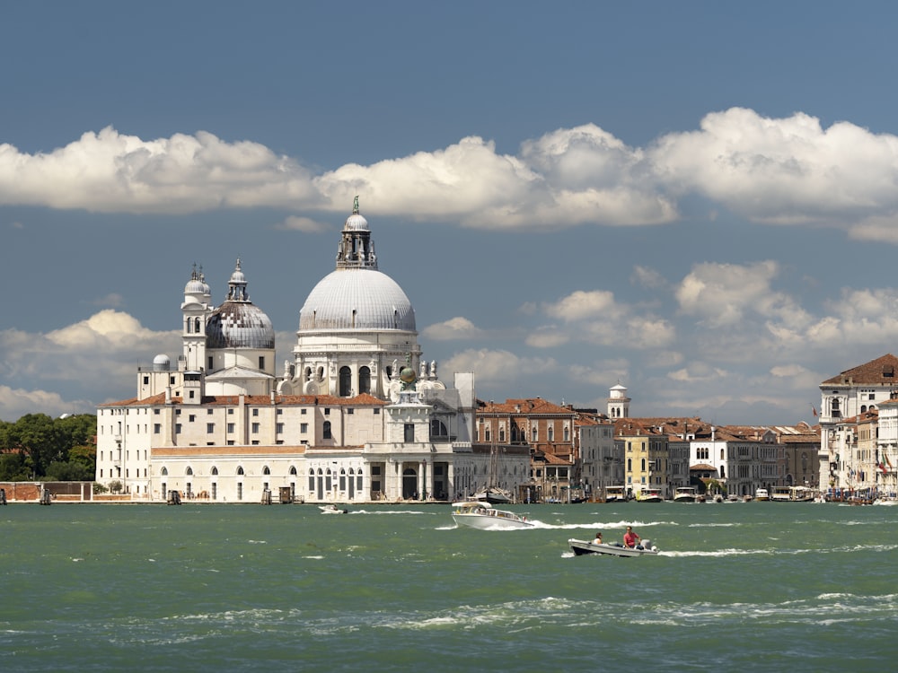 a large white building sitting on top of a body of water